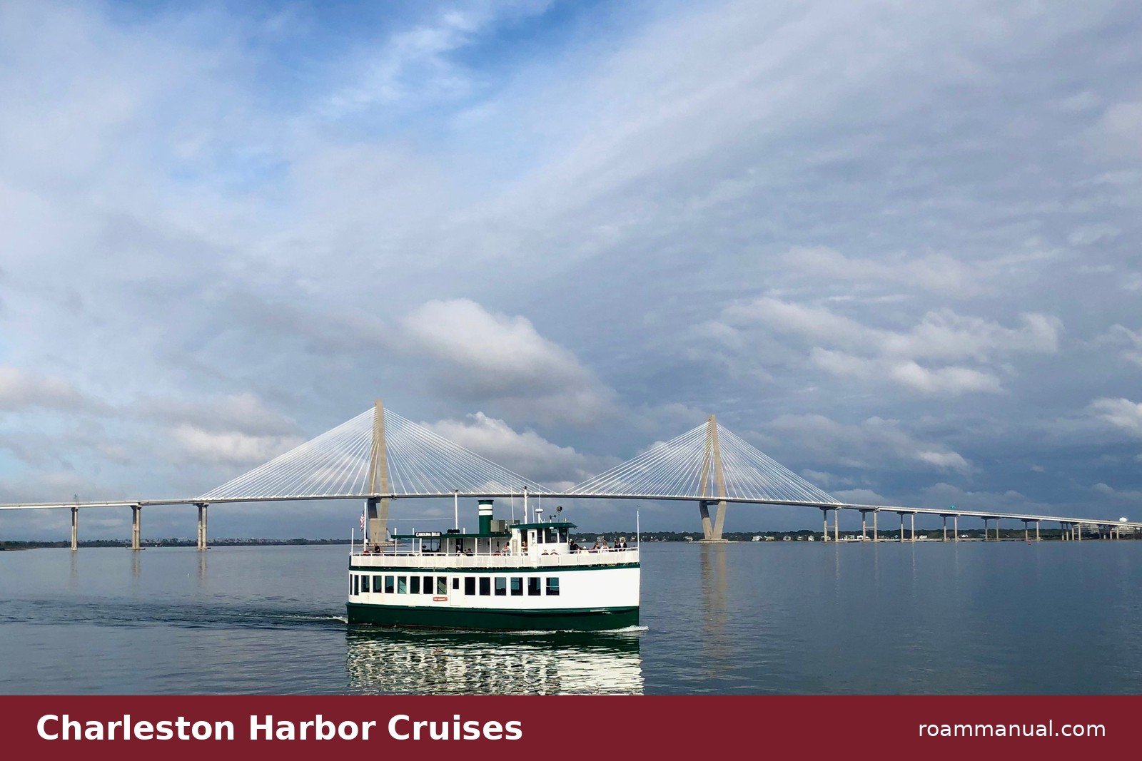 Tour boat cruising Charleston Harbor in front of the Arthur Ravenel Jr. Bridge