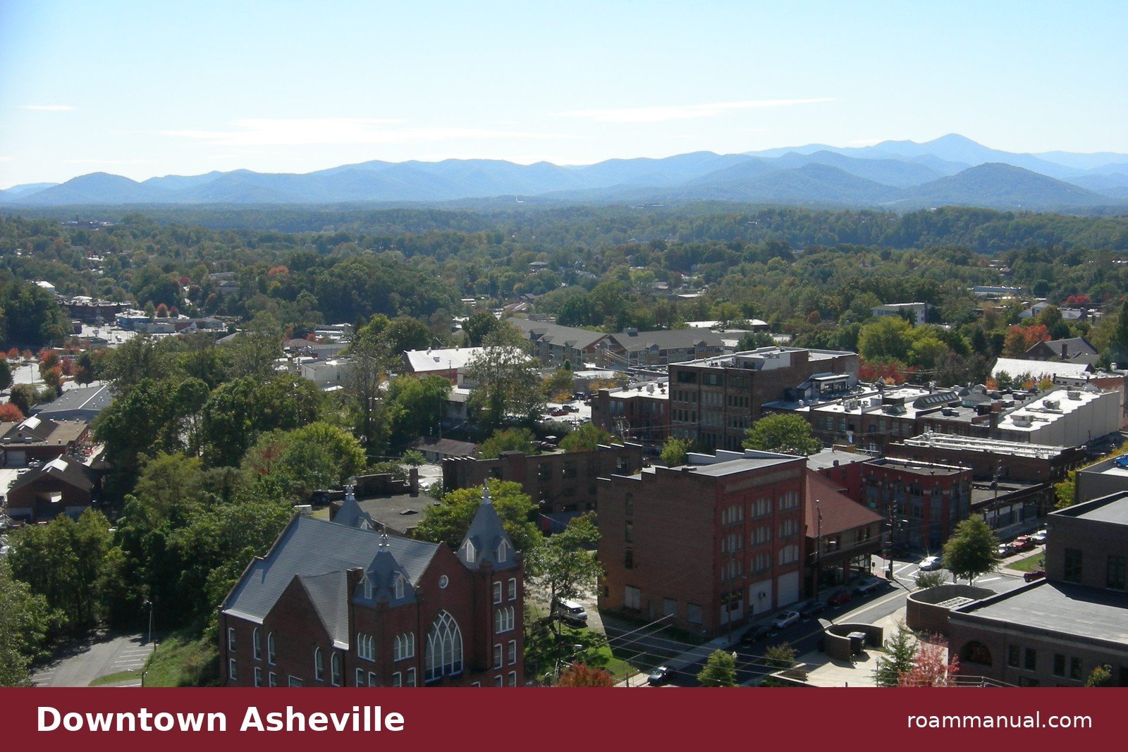 Downtown Asheville rooftops with the Blue Ridge Mountains behind, seen from Asheville City Hall