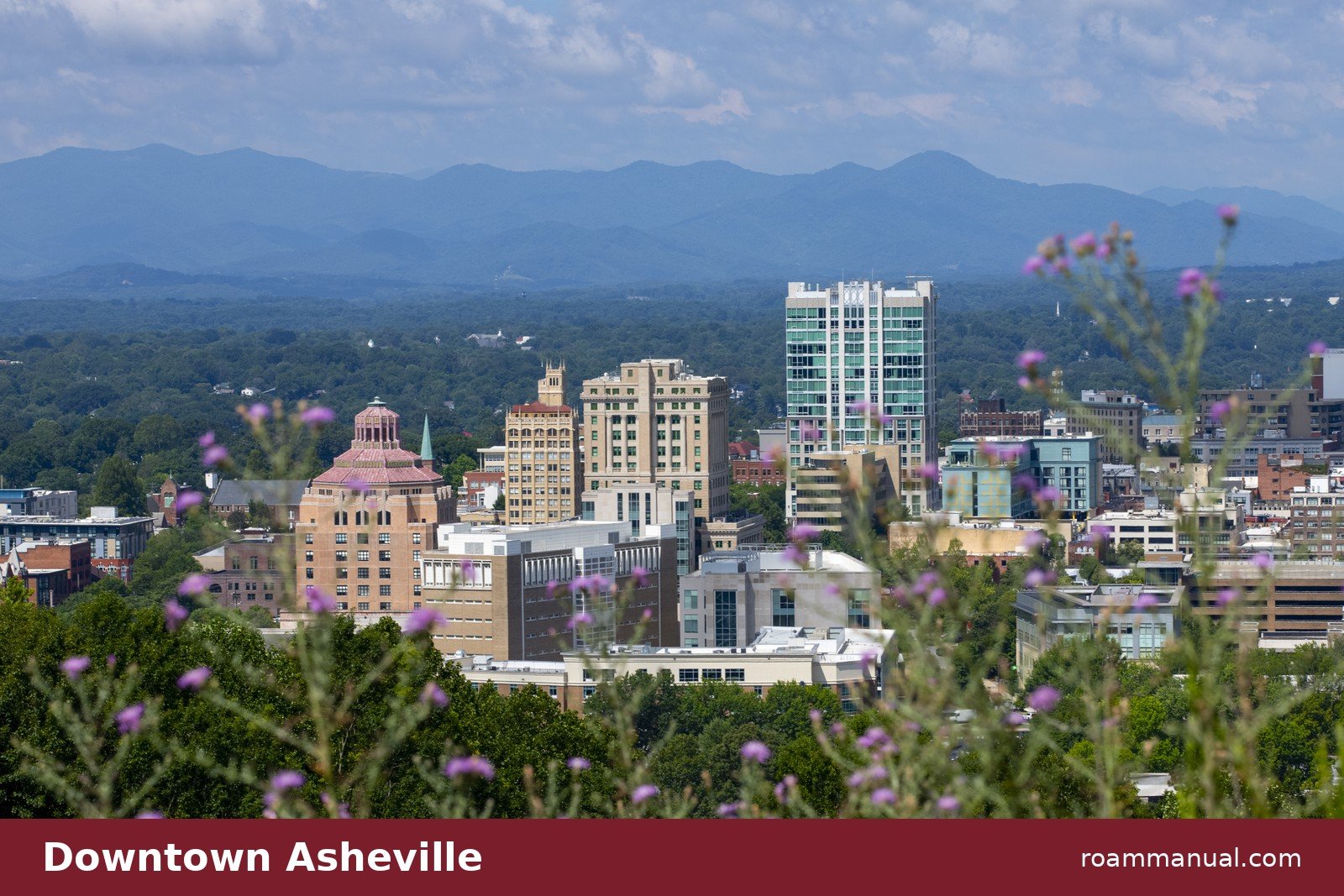 Downtown Asheville skyline with the Blue Ridge Mountains behind it, the heart of the Asheville brewery scene