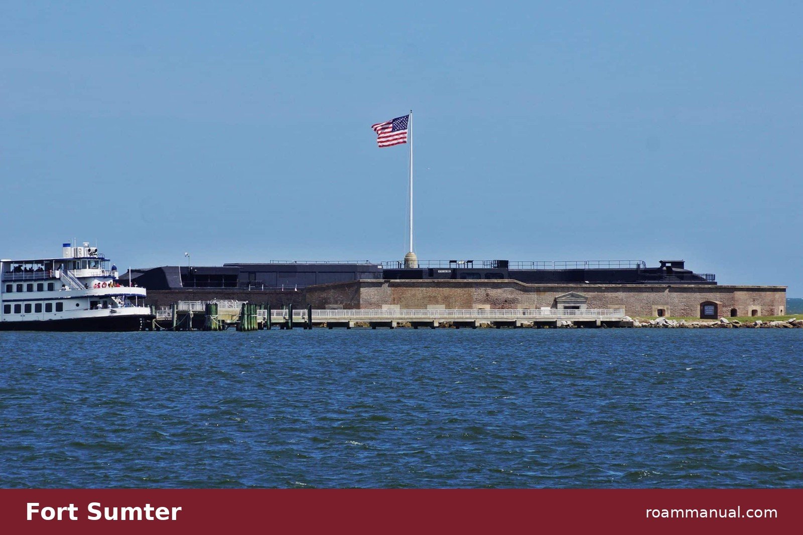 Fort Sumter in Charleston Harbor with a tour ferry docked beside the brick fort walls