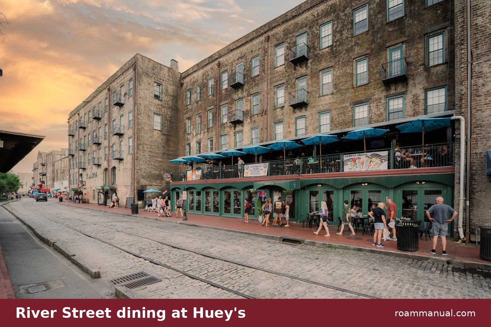Outdoor dining at Huey's on River Street in Savannah at sunset