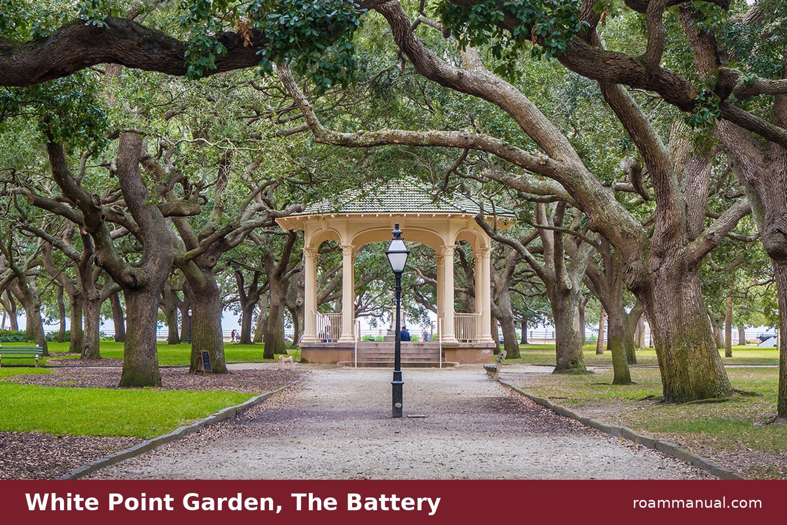 The bandstand at White Point Garden in Charleston, framed by twisting live oak trees at The Battery